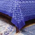 Elegant Traditional Indigo Craftsmanship Bring timeless Indian charm into your bedroom with this Indigo Printed Cotton Bedsheet, thoughtfully designed in a beautiful indigo pattern that adds character, warmth, and sophistication to your space. The rich blue tones and traditional-inspired print create an inviting look that blends effortlessly with both classic and contemporary interiors. Sized at 90 x 108 inches, this cotton bedsheet is generously designed for comfortable everyday use. The set also includes 2 matching pillow covers, making it an easy way to refresh your bedroom décor with coordinated style. Soft Cotton Comfort for Everyday Living Made from comfortable cotton fabric, this indigo bedsheet is ideal for those who appreciate natural textiles and relaxed elegance. The breathable feel of cotton makes it a practical choice for everyday bedding, while the attractive printed design gives your room a distinctive handcrafted-inspired aesthetic. Whether you're refreshing your master bedroom, guest room, or creating a cozy retreat, this 90 x 108 inch cotton bedsheet offers a beautiful combination of comfort and style. A Beautiful Touch of Indian Heritage Indigo has long been associated with India's rich textile traditions, making this indigo printed bedsheet more than just everyday bedding. Its traditional character brings an authentic Indian aesthetic into your home while maintaining a versatile look that works beautifully with modern décor. Pair it with wooden furniture, neutral cushions, woven accessories, or other handcrafted textiles to create a warm and artistic bedroom atmosphere. The matching pillow covers complete the coordinated look and make styling effortless. Why Choose This Indigo Bedsheet? 90 x 108 inches – generous size for comfortable bedroom use Includes 2 matching pillow covers Made from comfortable cotton fabric Beautiful printed indigo design Inspired by traditional Indian textile aesthetics Suitable for bedrooms, guest rooms, and home décor Easy way to add color and heritage charm to your interiors A thoughtful choice for lovers of Indian handicrafts and textiles This Printed Indigo Cotton Bedsheet with 2 Pillow Covers is a wonderful choice for anyone looking to combine everyday comfort with the timeless beauty of Indian-inspired textile design. Printed Indigo Cotton Bedsheet,Indigo Cotton Bedsheet Set,Indigo Bedsheet with Pillow Covers,90x108 Printed Indigo Bedsheet,Indian Indigo Cotton Bedsheet Printed Indigo Cotton Bedsheet